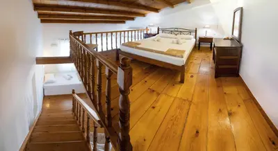 a bedroom with a bed and a wooden floor at Ontas Traditional Hotel in Chania Town