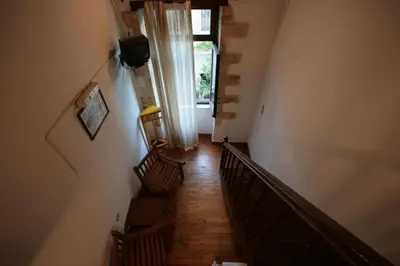 a hallway with a staircase with a window and a stair case at Chania Rooms in Chania Town