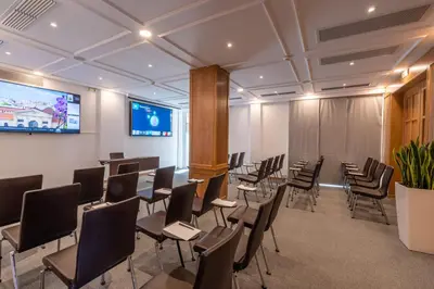a conference room with chairs and a projection screen at Kydon The Heart City Hotel in Chania Town