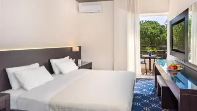 a hotel room with a bed and a balcony at Monte Vardia in Chania Town