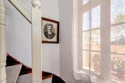 a picture of a man on a wall next to a window at Pension Eva in Chania Town