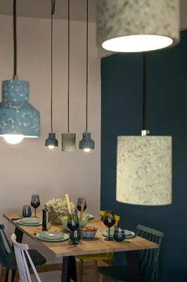 a dining room with a table with chairs and pendant lights at Alsalos Sea View Apartment in Chania Town