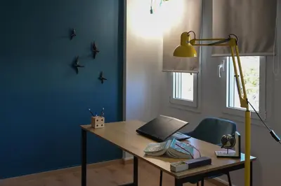 a desk with a laptop and a lamp in a room at Alsalos Sea View Apartment in Chania Town