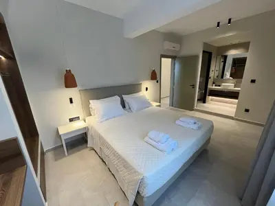 a bedroom with a bed with two towels on it at Mediterranean Sea Top Floor in Palaiochóra