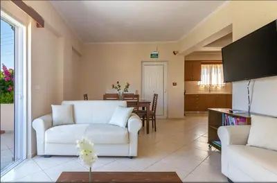 a living room with a white couch and a table at Selini Villas with private pool 10 minutes walking from the beach in Ropanianá