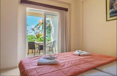 a bedroom with a bed with two towels on it at Selini Villas with private pool 10 minutes walking from the beach in Ropanianá