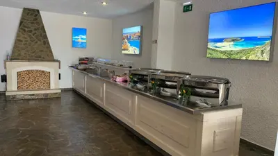 a restaurant with a counter in a room at Folia Apartments Chania in Agia Marina Nea Kydonias
