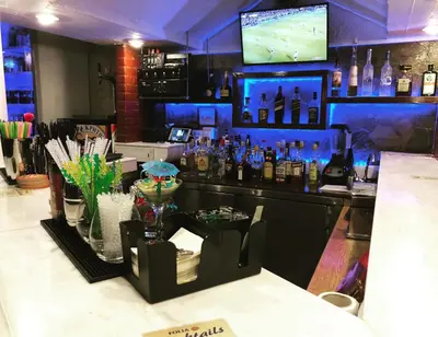 a bar with a lot of bottles of alcohol at Folia Apartments Chania in Agia Marina Nea Kydonias