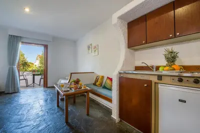 a kitchen and living room with a couch and a table at Folia Apartments Chania in Agia Marina Nea Kydonias