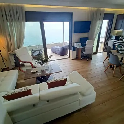 a living room with a white couch and a table at Olive and Aloe Villas in Nomikianá