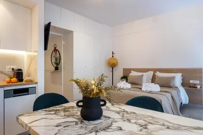 a bedroom with a bed and a table and chairs at Annet in Chania Town