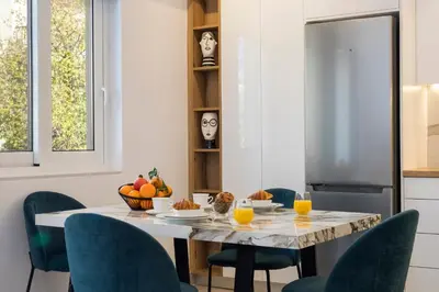 a dining room with a table and chairs with fruit on it at Annet in Chania Town
