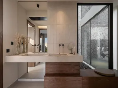 a bathroom with two sinks and a large window at Pnoe Villas - Seafront Experience in Tavronitis