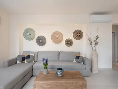 a living room with a couch and a coffee table at Calmaliving Seaside apartments with pool in Gerani Chanion