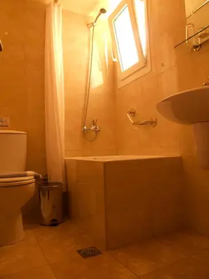 a bathroom with a shower and a toilet and a sink at Kissamos Hotel in Kissamos