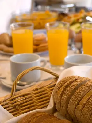 a table with bread and glasses of orange juice at Kissamos Hotel in Kissamos