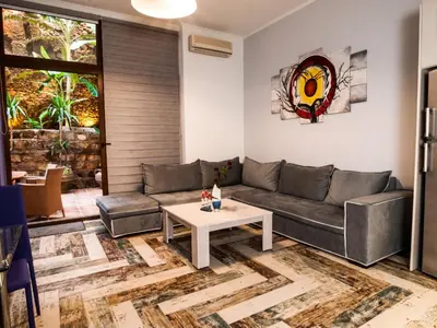 a living room with a couch and a table at Casa Kasteli in Chania Town