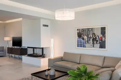 a living room with a couch and a tv at Villa Pirgos Luxury in Kissamos