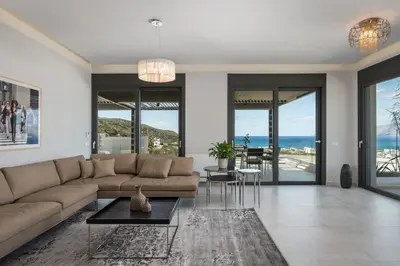 a living room with a couch and a table at Villa Pirgos Luxury in Kissamos