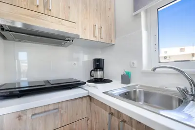 a kitchen with a sink and a microwave at Casa Maria 300 meters from the sea in Chania Town