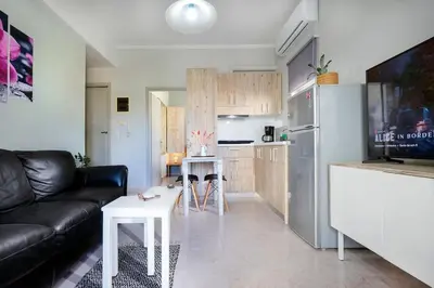a living room with a couch and a kitchen at Casa Maria 300 meters from the sea in Chania Town