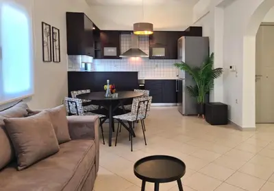 a living room and kitchen with a couch and a table at Anna & Zampia central apts in Kissamos