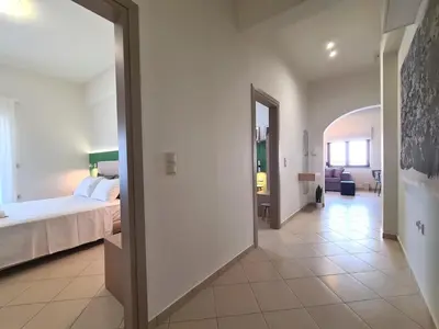 a bedroom with a bed and a hallway at Anna & Zampia central apts in Kissamos