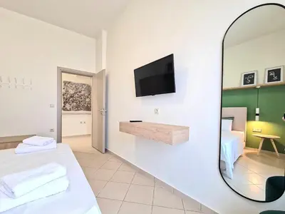 a room with a bed and a mirror at Anna & Zampia central apts in Kissamos