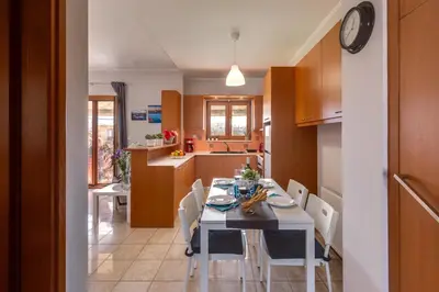 a kitchen and dining room with a table and chairs at Stema City Apartment in Chania Town