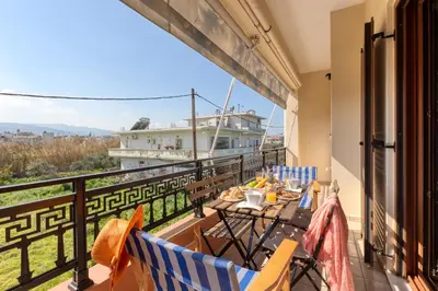 a balcony with chairs and a cruise ship in the background at Stema City Apartment in Chania Town