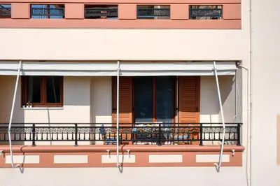 a balcony of a building with a porch at Stema City Apartment in Chania Town