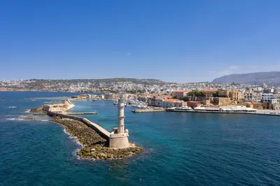 an island in the water with a city in the background at Stema City Apartment in Chania Town