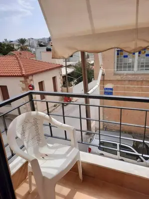 a white chair sitting on top of a balcony at Charming apartment in Halepa! in Chania Town
