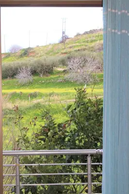 a window with a view of a grassy field at Kallia's Modern Apartment in Kissamos