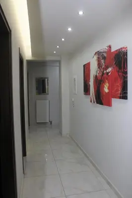 a hallway with paintings on the walls of a room at Kallia's Modern Apartment in Kissamos