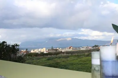 a view of a city with mountains in the background at Kallia's Modern Apartment in Kissamos