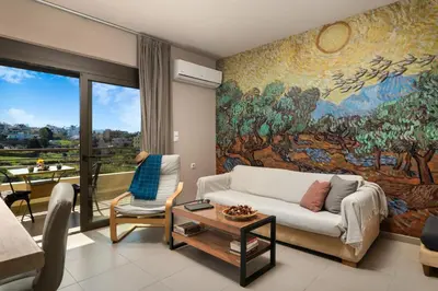 a living room with a large painting on the wall at Halepa Luxury Apartments in Chania Town