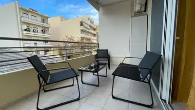 three chairs and a table on a balcony at Centro Apartment in Chania Town