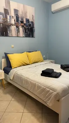 a bedroom with a bed with yellow and blue walls at Centro Apartment in Chania Town