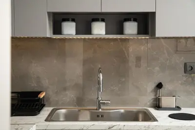 a kitchen sink with a faucet on a counter at 2 bd downtown home with private parking 400 meters walk to the beach in Chania Town