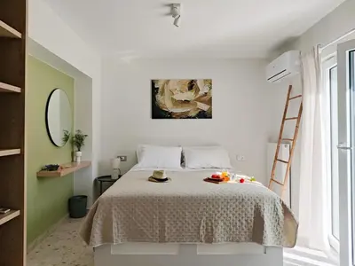 a bedroom with a bed and a painting on the wall at Thelma and Louise house in Mourniaí