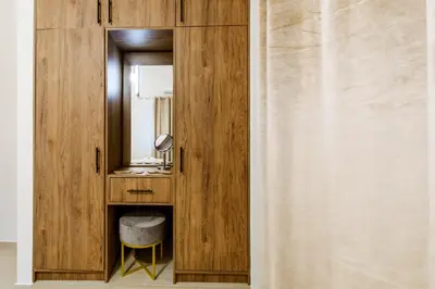 a bathroom with a wooden cabinet with a mirror at Porfyra Suite 2 in Chania Town