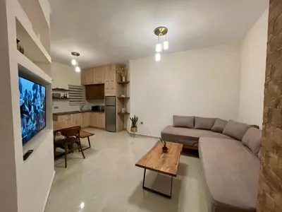 a living room with a couch and a table at Porfyra Suite 2 in Chania Town