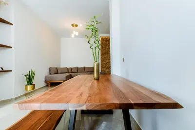 a wooden table in a living room with a couch at Porfyra Suite 2 in Chania Town