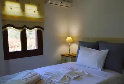 a bedroom with a bed with two towels on it at Villa Sobre - Spacious and Comfortable. in Kounoupidhianá