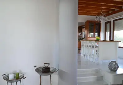 a dining room and kitchen with tables and chairs at Villa Sobre - Spacious and Comfortable. in Kounoupidhianá