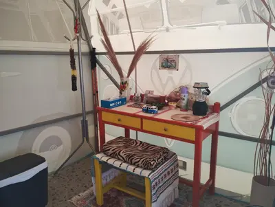 a room with a desk and a stool with a table at Cornelia Hippie Magic Bus in Kissamos