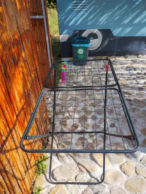 a metal rack in front of a building at Cornelia Hippie Magic Bus in Kissamos