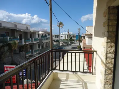 a balcony with a view of a street and buildings at ROMANTZA apartments in Agia Marina Nea Kydonias