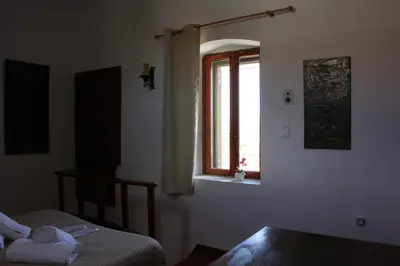 a bedroom with a bed and a window at Evanthea Residence in Kounoupidhianá